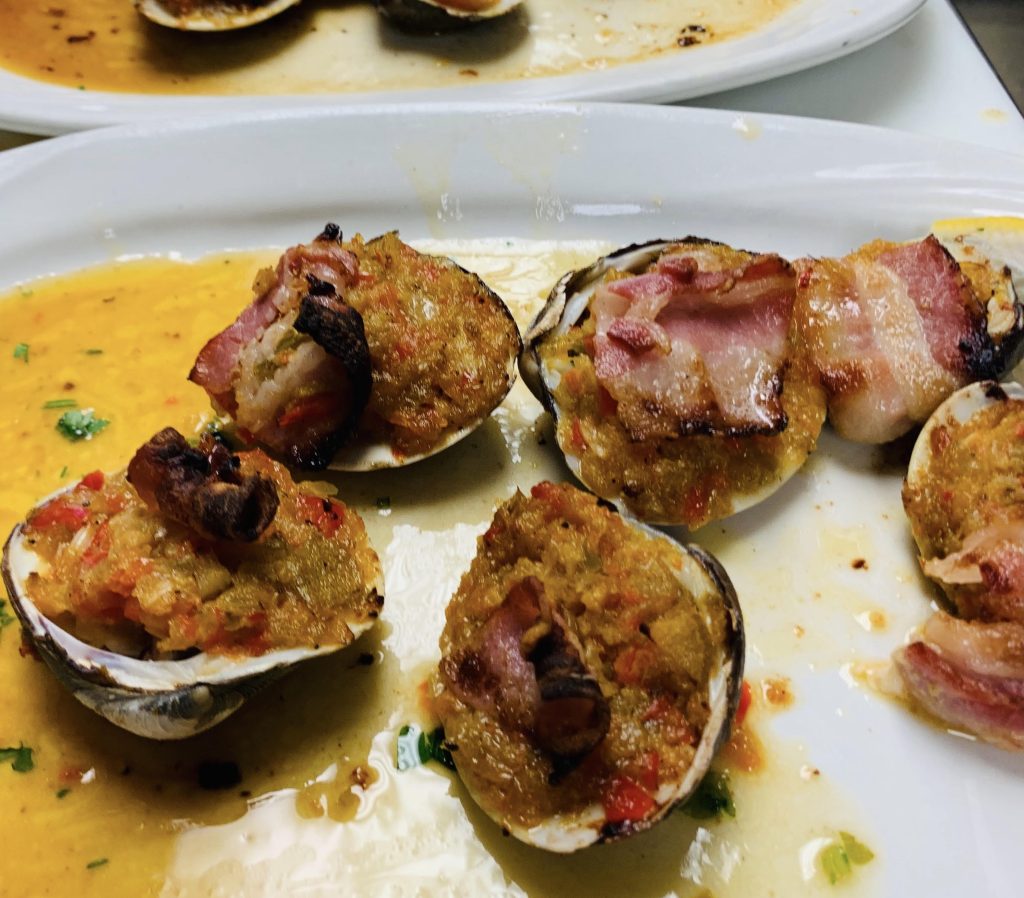 Clams with bacon and sauce on a plate.