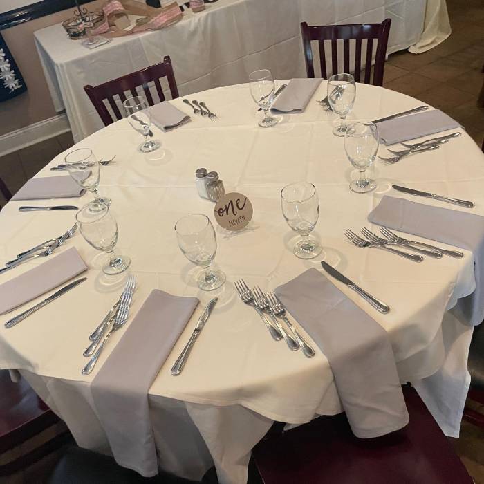 A table set up with silverware and napkins.